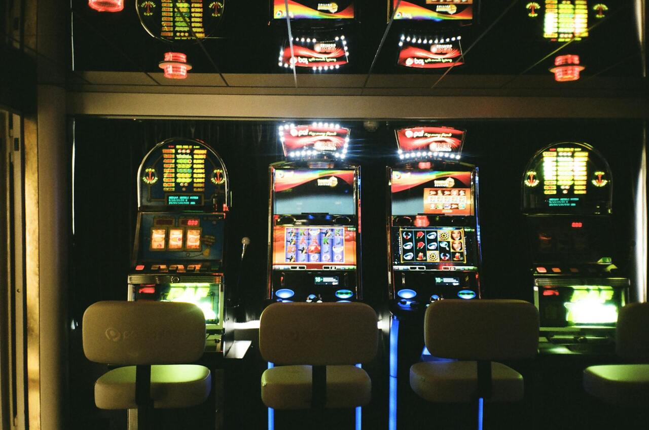 Image of 3 chairs in casino facing slot machines